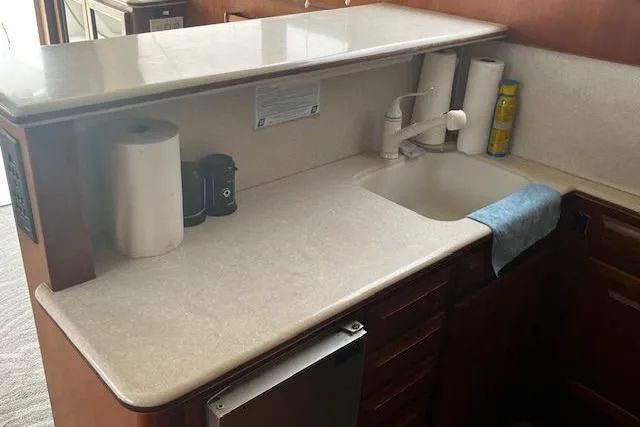Slide: The Image of 1988 Viking 45 Convertible yacht kitchen with sink, countertop, and storage cabinets. - 14