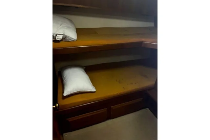 Slide: The Image of 1988 Viking 45 Convertible cabin with bunk beds and pillows. - 16