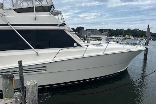 Slide: The Image of 1988 Viking 45 Convertible yacht docked at marina, side view. - 2