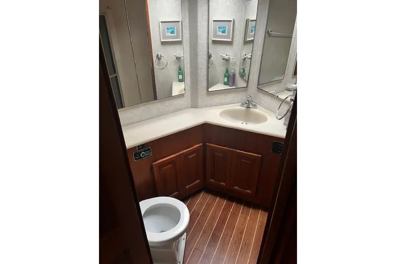 Slide: The Image of Bathroom interior of 1988 Viking 45 Convertible yacht with wood flooring and corner sink. - 20