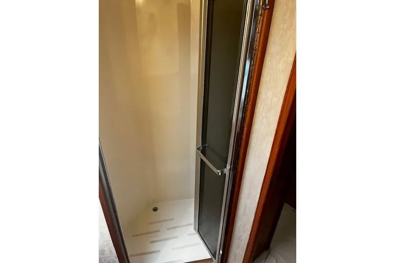 Slide: The Image of 1988 Viking 45 Convertible shower interior with glass door and white base. - 21