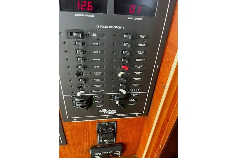 Slide: The Image of 1988 Viking 45 Convertible electrical panel with 12 volts DC circuits and battery voltage display. - 25
