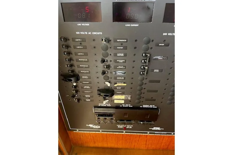 Slide: The Image of Electrical panel of 1988 Viking 45 Convertible boat, showing circuit breakers and controls. - 26