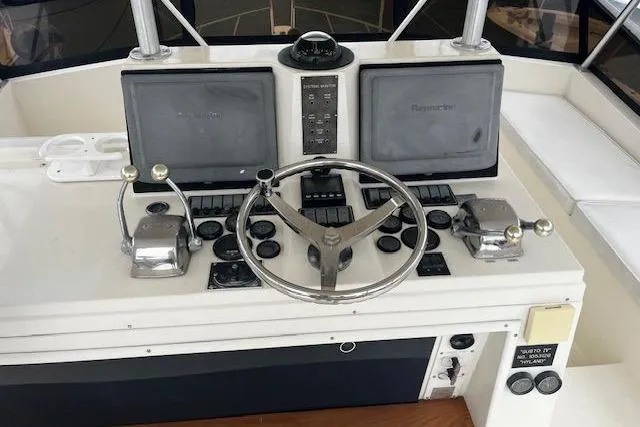 Slide: The Image of 1988 Viking 45 Convertible boat helm with dual controls and navigation screens. - 28