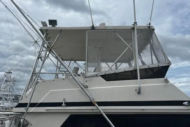 Slide: The Image of 1988 Viking 45 Convertible boat with enclosed flybridge under cloudy sky. - 3