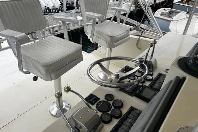 Slide: The Image of 1988 Viking 45 Convertible boat helm with dual seats and control panel. - 30