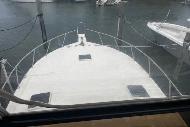 Slide: The Image of 1988 Viking 45 Convertible boat docked, view from the bow, must sell. - 35