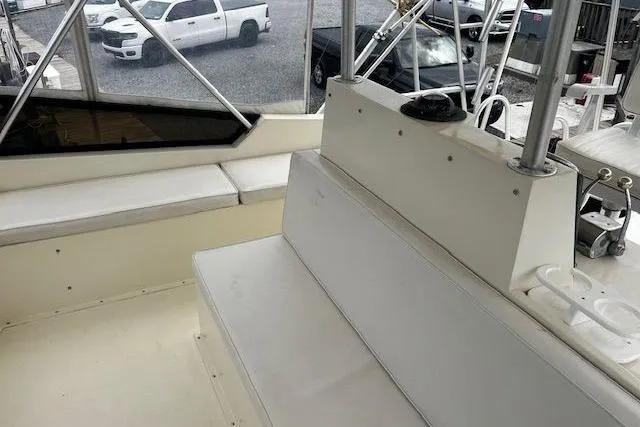 Slide: The Image of 1988 Viking 45 Convertible boat interior with seating and helm, must sell. - 36