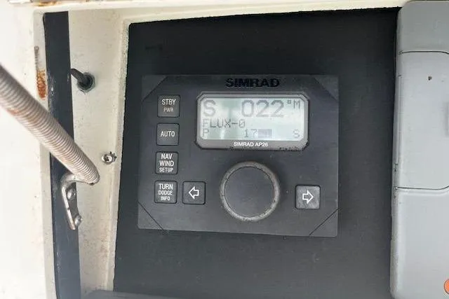 Slide: The Image of Simrad AP26 control panel on 1988 Viking 45 Convertible boat dashboard. - 38