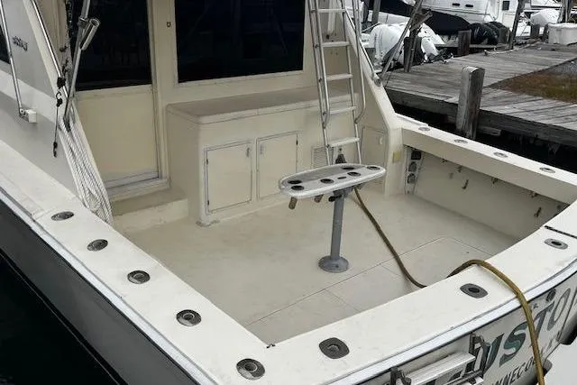 Slide: The Image of 1988 Viking 45 Convertible boat deck with ladder and fishing rod holders. - 5