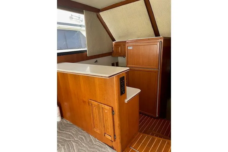 Slide: The Image of 1988 Viking 45 Conv interior with wooden cabinetry and compact kitchen area. - 8
