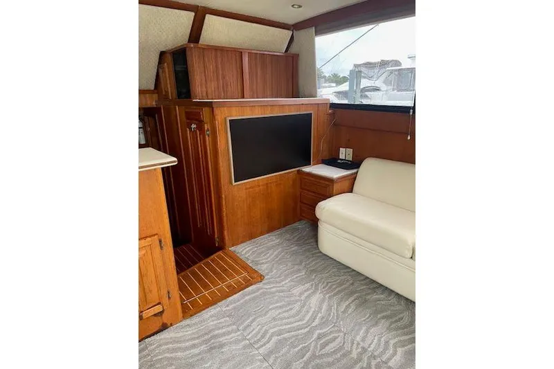 Slide: The Image of Interior of 1988 Viking 45 Convertible yacht with wood paneling and modern amenities. - 9