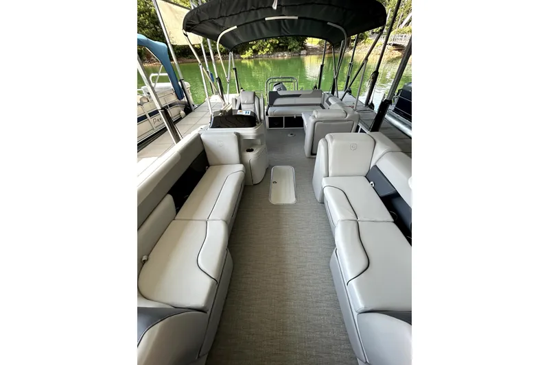Slide: The Image of 2025 Godfrey SWEETWATER 2286 SFL pontoon boat interior with spacious seating and canopy. - 15