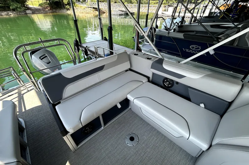 Slide: The Image of 2025 Godfrey SWEETWATER 2286 SFL pontoon boat interior with gray seating and lake view. - 4