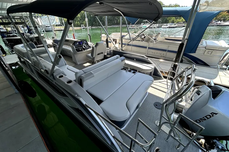 Slide: The Image of 2025 Godfrey SWEETWATER 2286 SFL pontoon boat with spacious seating and Honda outboard motor. - 5