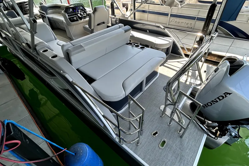 Slide: The Image of 2025 Godfrey SWEETWATER 2286 SFL pontoon boat with Honda outboard motor, docked. - 6