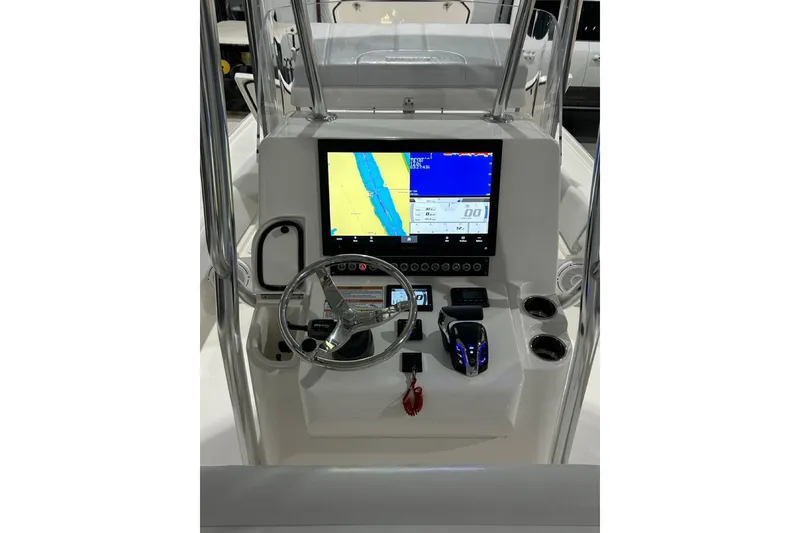 Slide: The Image of 2024 Contender 26 Bay boat console with navigation display and steering wheel. - 10