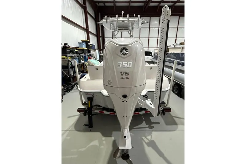 Slide: The Image of 2024 Contender 26 Bay boat with powerful 350 V6 engine in a storage facility. - 11