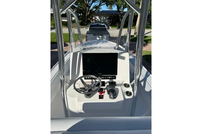 Slide: The Image of 2024 Contender 26 Bay boat console with steering wheel and controls. - 4