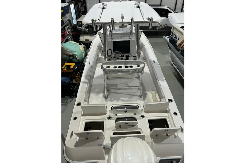 Slide: The Image of 2024 Contender 26 Bay boat interior with open storage compartments and helm station. - 5