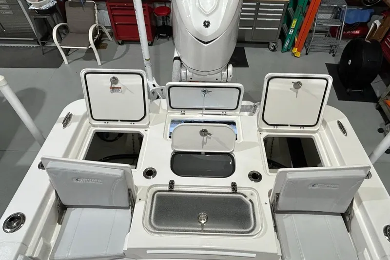 Slide: The Image of 2024 Contender 26 Bay boat interior with open storage compartments and seating. - 7