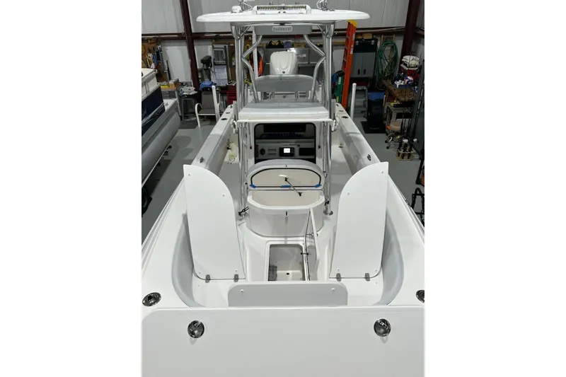 Slide: The Image of 2024 Contender 26 Bay boat interior with open hatches in a storage facility. - 8