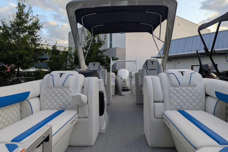 Slide: The Image of Luxurious 2026 Trifecta 25 RF SS Arch pontoon boat with plush seating and modern design. - 11