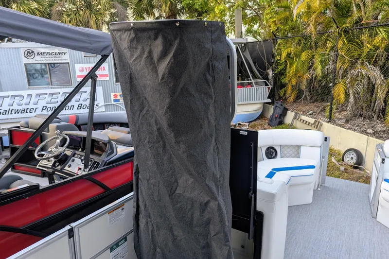 Slide: The Image of 2026 Trifecta 25 RF SS Arch pontoon boat interior with steering wheel and seating. - 13