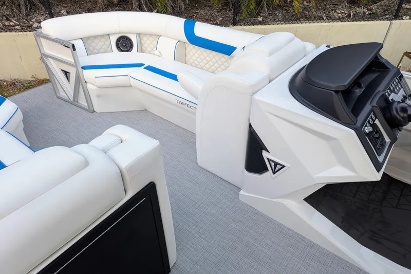 Slide: The Image of 2026 Trifecta 25 RF SS Arch boat interior with white and blue seating, modern helm. - 15