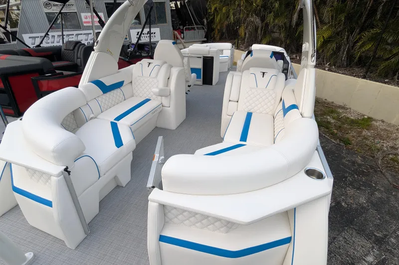 Slide: The Image of Luxurious 2026 Trifecta 25 RF SS Arch pontoon boat with elegant white and blue seating. - 18