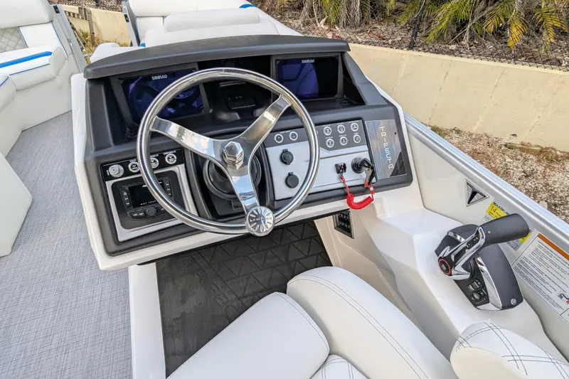 Slide: The Image of 2026 Trifecta 25 RF SS Arch boat dashboard with steering wheel and controls. - 6