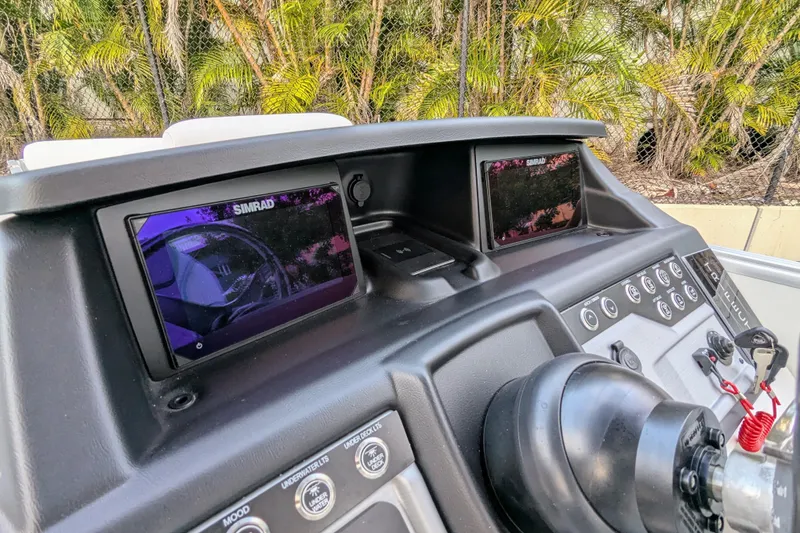 Slide: The Image of 2026 Trifecta 25 RF SS Arch boat dashboard with dual Simrad displays. - 7