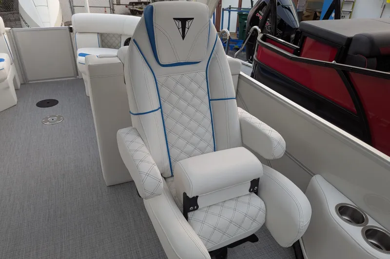 Slide: The Image of Luxurious seating on 2026 Trifecta 25 RF SS Arch boat, featuring white upholstery with blue accents. - 9