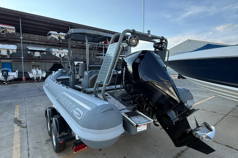 Slide: The Image of 2025 Highfield Sport 660 boat with powerful outboard motor in a marina setting. - 11