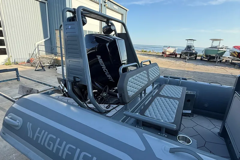 Slide: The Image of 2025 Highfield Sport 660 boat with Mercury engine, docked near other boats. - 8