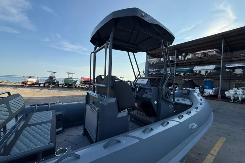 Slide: The Image of 2025 Highfield Sport 660 boat docked, showcasing interior and control console. - 9