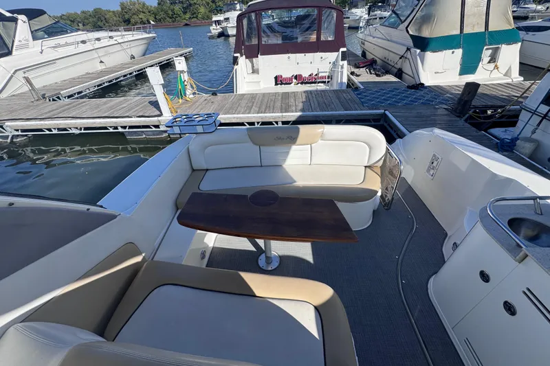 Slide: The Image of 2008 Sea Ray 350 Sundancer interior with seating and table at marina dock. - 14