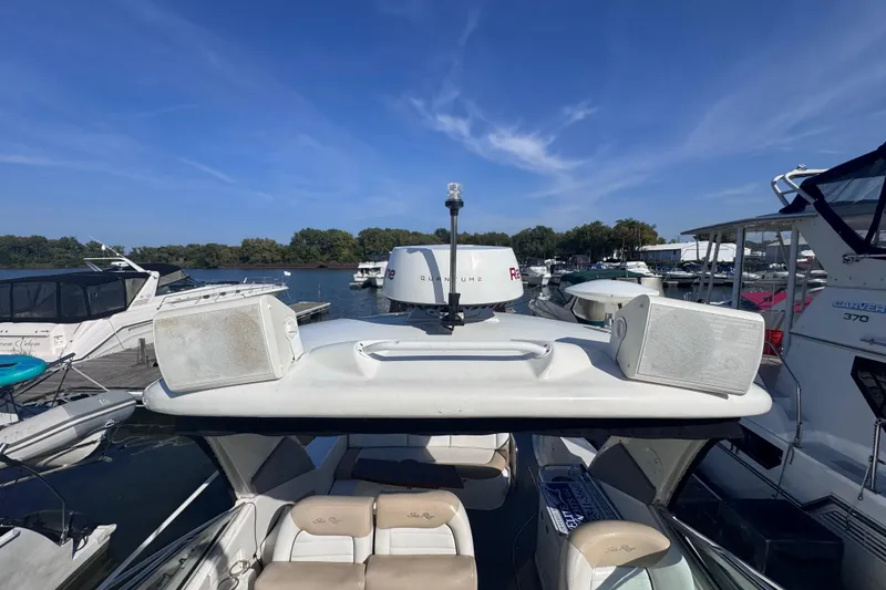 Slide: The Image of 2008 Sea Ray 350 Sundancer docked at marina, surrounded by other boats under clear blue sky. - 15