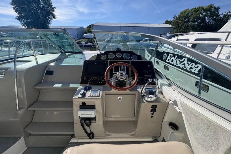 Slide: The Image of 2008 Sea Ray 350 Sundancer helm with steering wheel and control panel. - 23