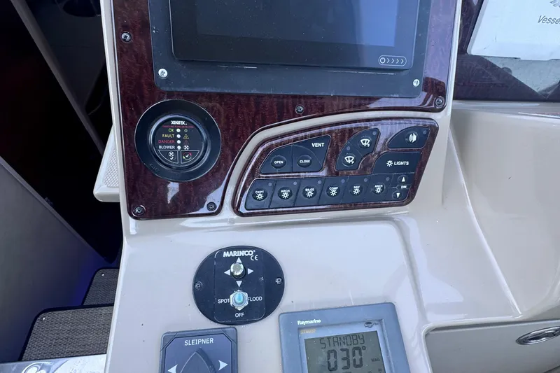 Slide: The Image of Control panel of a 2008 Sea Ray 350 Sundancer boat with various switches and displays. - 24