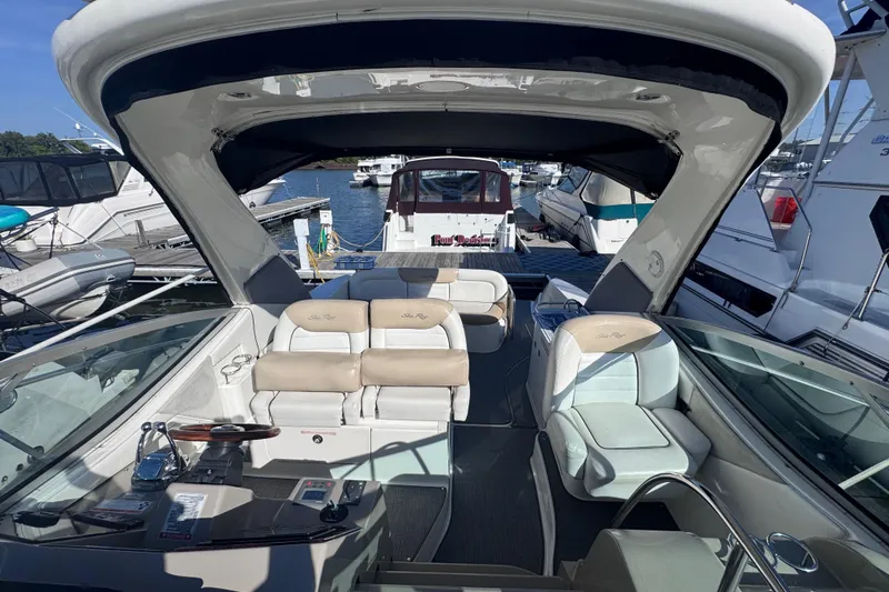 Slide: The Image of 2008 Sea Ray 350 Sundancer interior with seating, docked among other boats. - 26