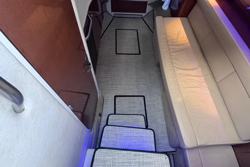 Slide: The Image of Interior of 2008 Sea Ray 350 Sundancer with beige seating and carpeted flooring. - 29