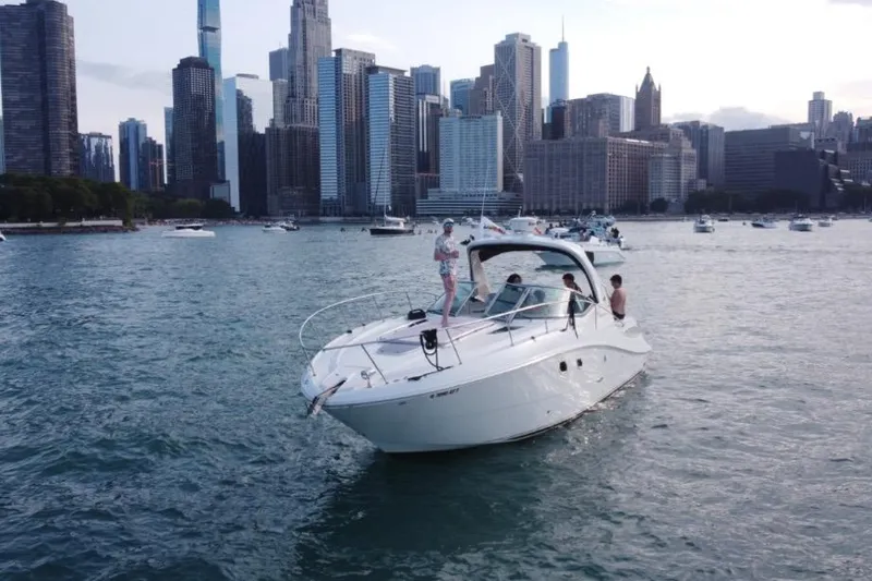 Slide: The Image of 2008 Sea Ray 350 Sundancer cruising near city skyline with people on deck. - 4