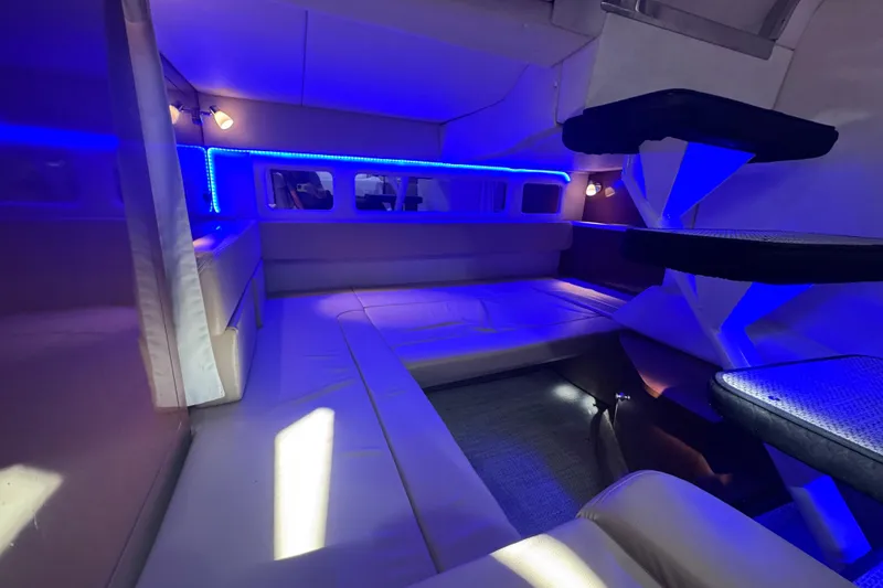 Slide: The Image of Luxurious interior of 2008 Sea Ray 350 Sundancer with blue LED lighting and plush seating. - 42