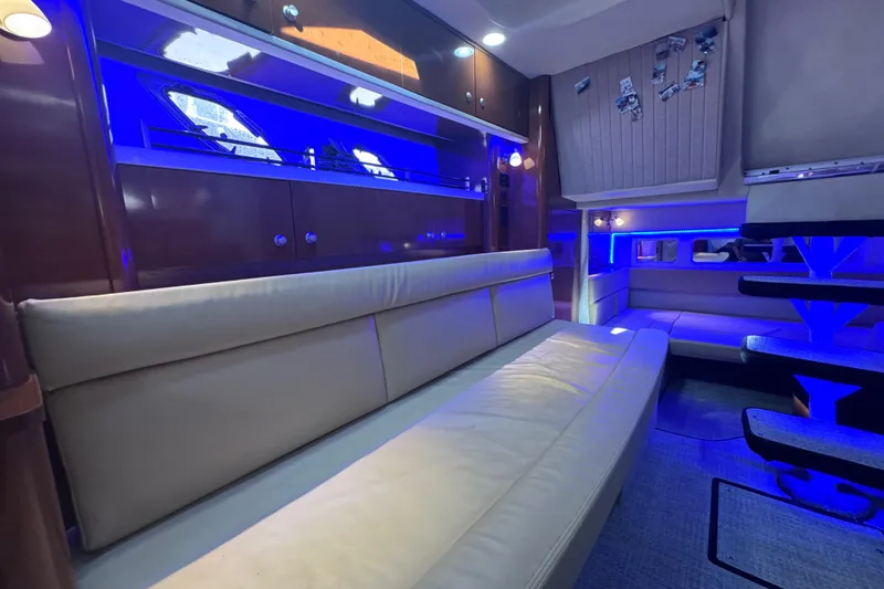 Slide: The Image of Luxurious interior of 2008 Sea Ray 350 Sundancer with blue ambient lighting and leather seating. - 43