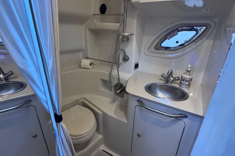 Slide: The Image of 2008 Sea Ray 350 Sundancer bathroom with shower, sink, and porthole window. - 45
