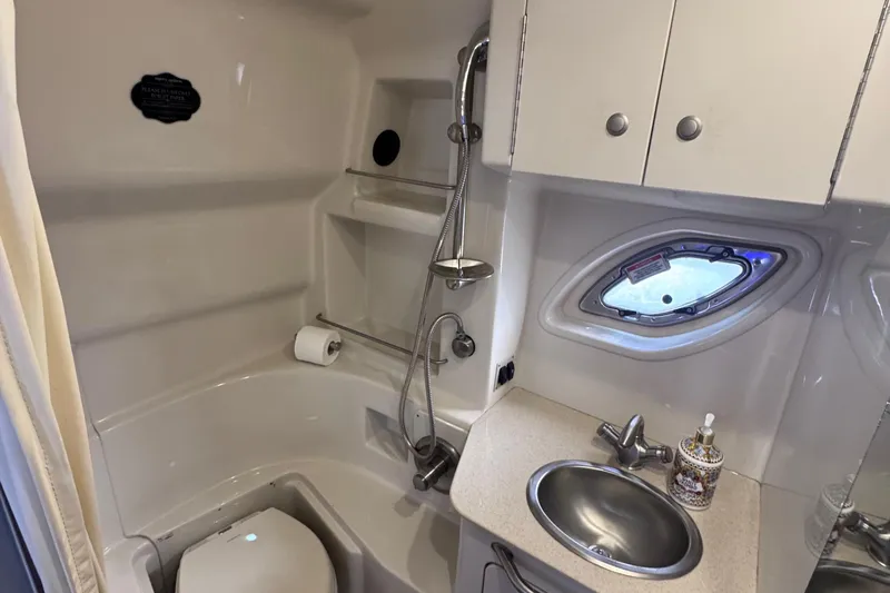 Slide: The Image of 2008 Sea Ray 350 Sundancer bathroom with shower, sink, and porthole window. - 48