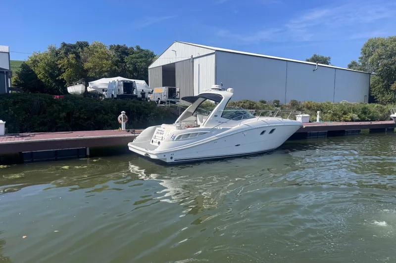 Slide: The Image of 2008 Sea Ray 350 Sundancer docked by a marina with clear blue skies. - 57