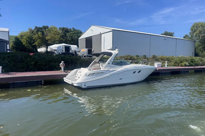 Slide: The Image of 2008 Sea Ray 350 Sundancer yacht docked by a marina under clear blue skies. - 58