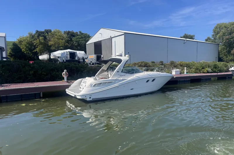 Slide: The Image of 2008 Sea Ray 350 Sundancer docked at marina with blue sky background. - 59